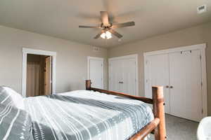 Bedroom featuring multiple closets and ceiling fan