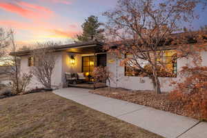 View of front of property with a yard and a carport