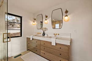 Bathroom featuring tile patterned flooring and vanity