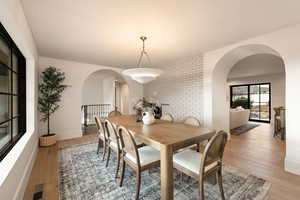 Dining space with light hardwood / wood-style flooring