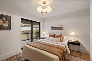 Bedroom with access to exterior and wood-type flooring