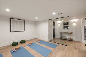 Workout room featuring hardwood / wood-style flooring