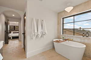 Bathroom with tile walls and a washtub