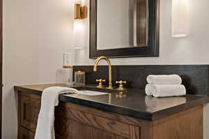 Bathroom with vanity and backsplash