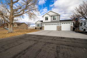 Beautiful Craftsmans Style home with 3 car garage, additional parking on side and rear of property with an additional 2 car garage on .80 acre