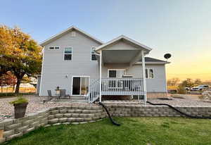 Summer View of covered deck and patio where you can spend enjoying your peaceful evenings.