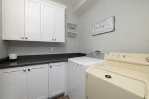 Main Level Laundry with storage space and countertop for folding clothes