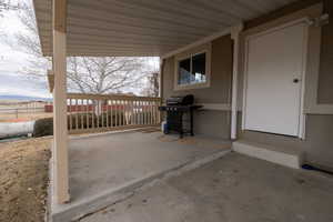 View of covered patio with a mountain view and grilling area