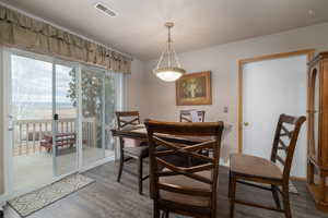 Dining space with access to deck through the sliding glass doors and access to garage