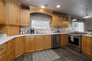 Beautiful maple cabinets in kitchen with solid-surface countertops