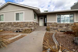 View of entrance to property with beautiful landscaping