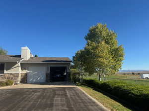 2 car garage with lots of storage and mature trees and shrubs - Summer View