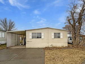 View of side of property featuring a carport