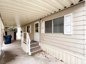 View of patio with a shed