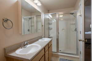 Bathroom featuring vanity and an enclosed shower