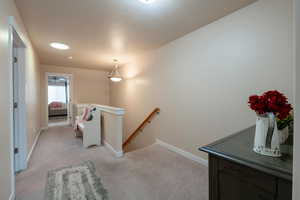 Corridor with light colored carpet