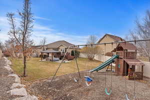 View of playground with a gazebo and a lawn