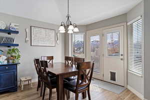 Dining area featuring a chandelier and light wood-type flooring