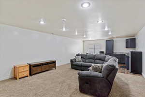 Living room featuring carpet flooring and a textured ceiling