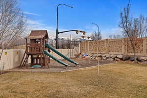 View of playground with a lawn