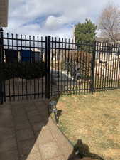 View of gate with a lawn