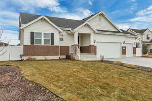 View of front of home with a garage and a front yard