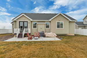 Back of house featuring french doors, a yard, and a patio