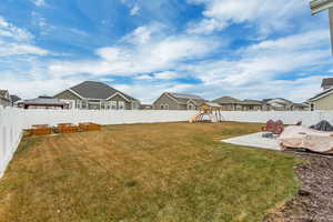 View of yard with a patio area and a playground