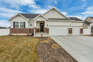 View of front facade with a garage and a front yard