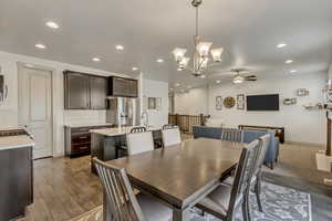 Dining area with ceiling fan, sink, and light wood-type flooring