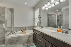 Bathroom featuring independent shower and bath and vanity