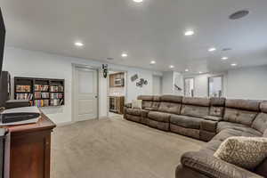 Carpeted living room featuring beverage cooler and bar area