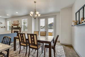 Dining room featuring light hardwood / wood-style flooring and a notable chandelier