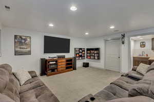 Living room featuring light carpet and sink