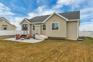 Back of property with a patio area and a lawn