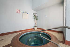 View of pool with an indoor in ground hot tub