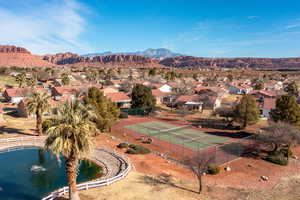 Birds eye view of property with a water and mountain view