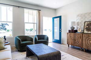 Living room with plenty of natural light and light hardwood / wood-style floors