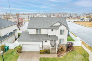 View of front facade featuring a garage and a front yard