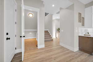 Hall with light hardwood / wood-style flooring