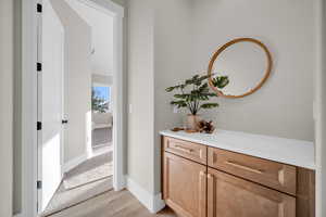 Corridor with light hardwood / wood-style floors