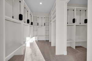 Mudroom with light colored carpet