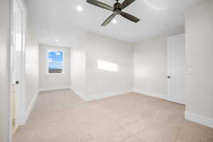 Carpeted empty room with ceiling fan