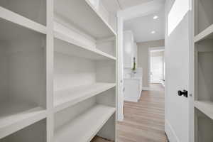 Walk in closet featuring light hardwood / wood-style flooring