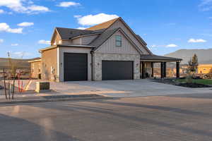 View of front facade with a garage and a mountain view