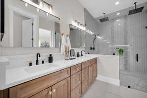 Bathroom with vanity and a shower with shower door