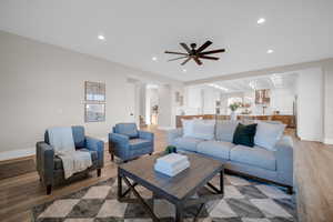 Living room featuring ceiling fan and light hardwood / wood-style floors