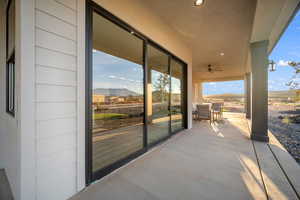 View of patio featuring a mountain view and ceiling fan