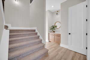 Staircase with hardwood / wood-style flooring