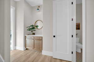 Corridor with light wood-type flooring